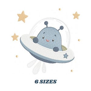 May include: An embroidered design featuring a friendly blue alien in a spaceship, surrounded by gold stars and dots. The text "6 SIZES" is displayed below the image. The design has a whimsical, cartoonish style.