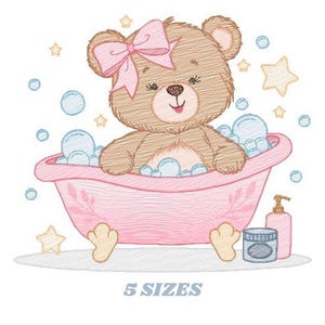 May include: Embroidered design of a brown teddy bear wearing a pink bow, sitting in a pink bathtub with blue bubbles. There are stars and bubbles in the background. The text "5 SIZES" is at the bottom of the image.