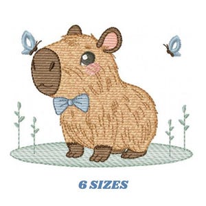 May include: Embroidered design of a brown capybara wearing a blue bow tie and surrounded by blue butterflies. The capybara is standing on a green patch of grass. The design is available in 6 sizes.