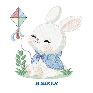 May include: An embroidered design of a white bunny wearing a blue jacket, holding a kite with colorful accents. The bunny is sitting in grass, with the text "5 SIZES" below.