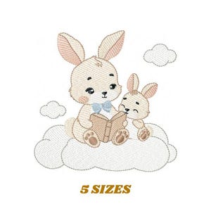 May include: Embroidered design of two brown bunnies sitting on a white cloud, reading a book together. The larger bunny is wearing a blue bow tie.
