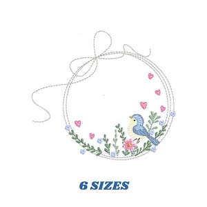 May include: A blue bird with a yellow breast sits in a wreath of green leaves and pink and blue flowers. The wreath is tied with a bow and has a gray outline. The text "6 SIZES" is below the wreath.
