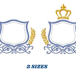 May include: Two embroidery designs featuring a blue shield with gold accents. The shield is surrounded by a decorative scroll design and two wheat stalks. One design includes a gold crown on top of the shield. The text "2 SIZES" is below the designs.
