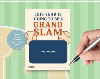 May include: A baseball-themed gift card with the text "THIS YEAR IS GOING TO BE A GRAND SLAM." The card features baseballs and a dark blue area for a gift card. A hand is holding a pen.