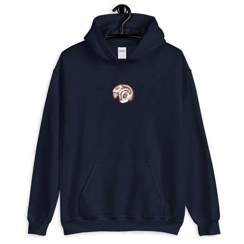 May include: A navy blue hooded sweatshirt with a small embroidered image of a cartoon character wearing a helmet. The character is red, white, and orange.