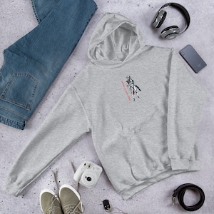 May include: Gray hooded sweatshirt with a white and gray illustration of a character with a red text overlay that says "Always Coming Back".