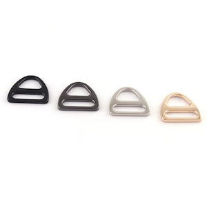 May include: Four metal D-ring buckles in black, gunmetal, silver, and gold.