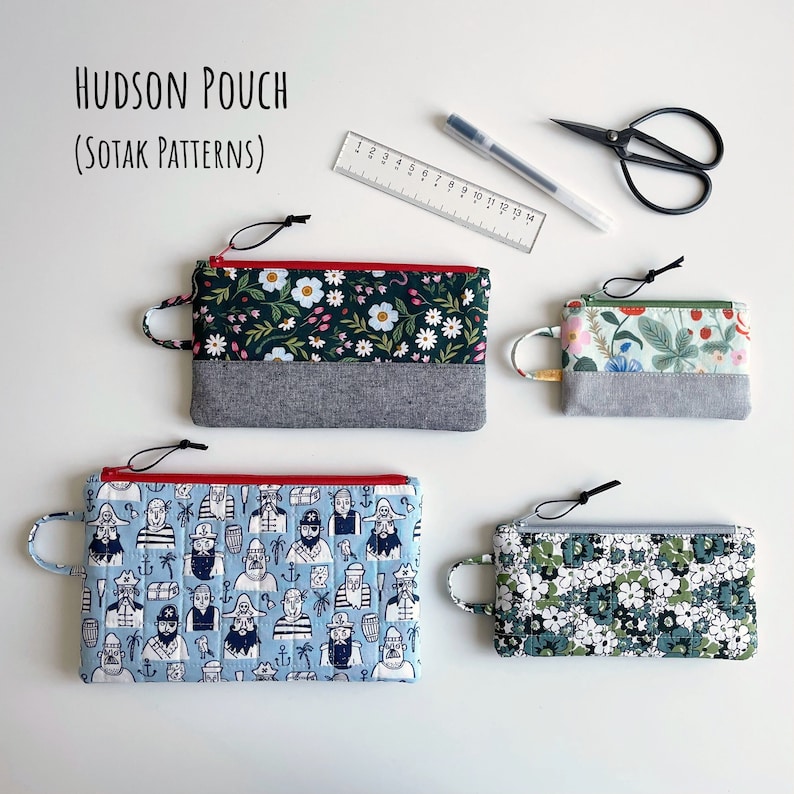 May include: Four different fabric pouches with zipper closures. The pouches are in various patterns, including floral, nautical, and geometric designs. The pouches are labeled "HUDSON POUCH (SOTAK PATTERNS)".