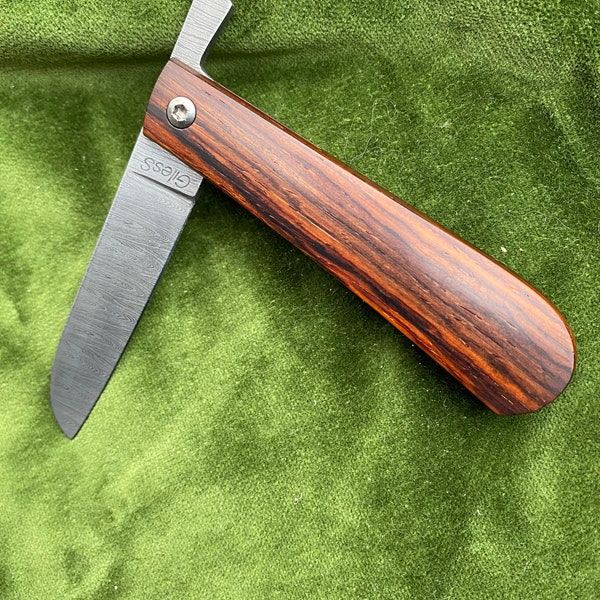 Friction folder in Cocobolo with twisted Damascus blade