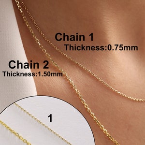 May include: Two gold chains, one thicker than the other, are shown on a person's neck. The thicker chain is labeled "Chain 2, Thickness: 1.50mm" and the thinner chain is labeled "Chain 1, Thickness: 0.75mm".