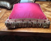 Ruby red faux silk cushion with long fringe