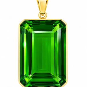 May include: A rectangular pendant featuring a large, vibrant green gemstone set in a polished yellow gold frame. The stone has an emerald-cut design with clear facets that reflect light, and the pendant includes a gold bail at the top.