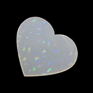 May include: A clear heart-shaped resin coaster with iridescent glitter embedded in the resin.