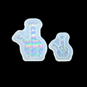 May include: Two clear silicone molds for making resin crafts. The molds are shaped like bongs, one large and one small. The molds are translucent and have a holographic finish.