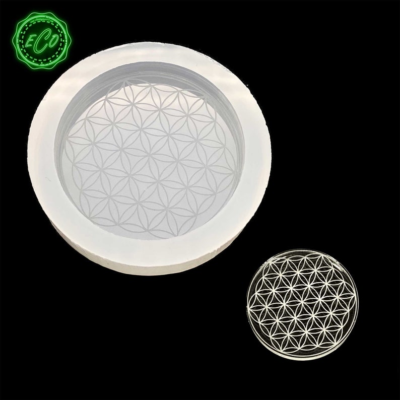 May include: A white silicone mold with a flower of life design. The mold is round and has a raised edge. The flower of life design is intricate and detailed.