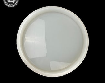 May include: White round silicone mold for resin crafts. The mold has a smooth, glossy finish and a raised rim.