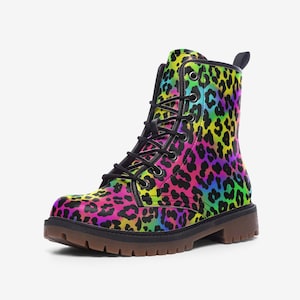 May include: A combat boot featuring a vibrant leopard print in shades of pink, yellow, blue, and green. The boot has black laces, a black collar, and a brown sole. The boot is a stylish and colorful footwear option.