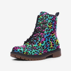 May include: Black leather boots with a colorful leopard print pattern. The boots have a lace-up closure and a chunky sole.