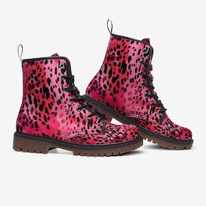 May include: Pink leopard print lace-up boots with black laces and a brown rubber sole.