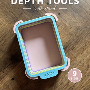 May include: A set of nested rectangular polymer clay depth tools in pastel blue, yellow, and pink, featuring a stand. The tool is labelled 1 MM and includes a circular graphic indicating 9 SIZES. Text reads POLYMER CLAY DEPTH TOOLS with stand.