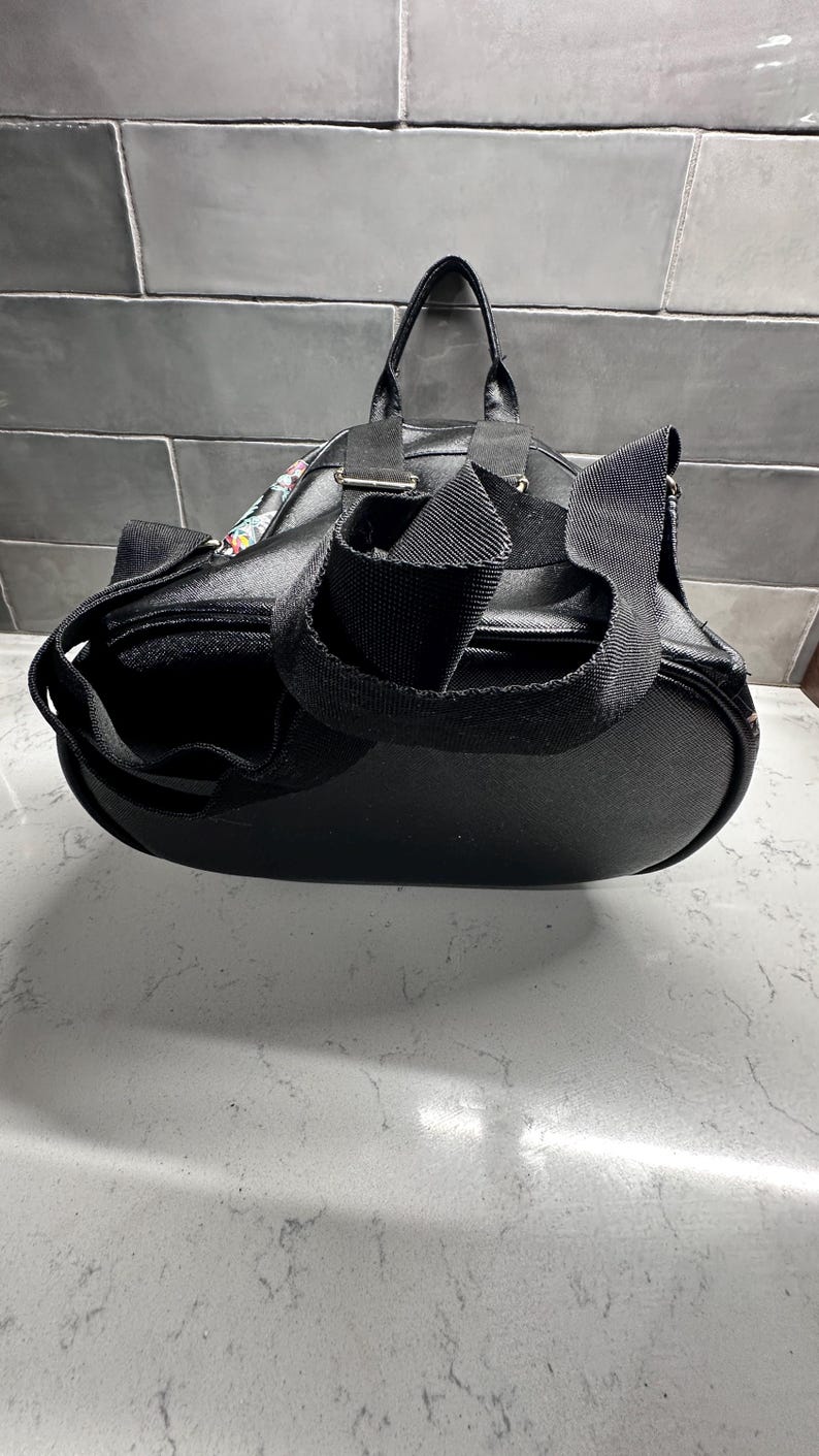 May include: A white ceramic mug with a black handle and the text "But First, Coffee" in a handwritten style. The mug is on a white surface. The mug is 4 inches tall.