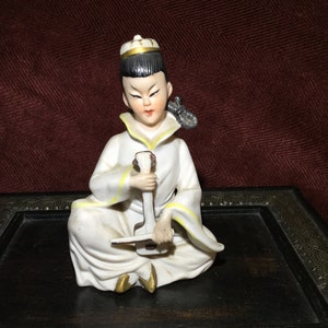 Oriental figurine boy with musical Instrument