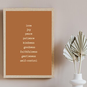May include: A framed print with a brown background and white text. The text reads "love, joy, peace, patience, kindness, goodness, faithfulness, gentleness, self-control".