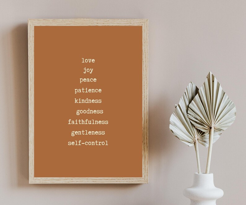 May include: A framed print with a brown background and white text. The text reads "love, joy, peace, patience, kindness, goodness, faithfulness, gentleness, self-control".