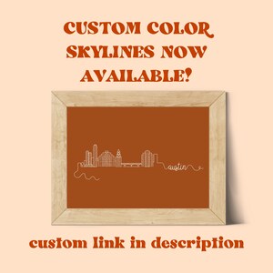 May include: A framed print of the Austin, Texas skyline in white line art on a burnt orange background. The text "CUSTOM COLOR SKYLINES NOW AVAILABLE!" is above the image and "custom link in description" is below the image.