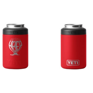 May include: Two red YETI can coolers. One has a silver graphic with the word "HREF" and a tree-like design. The other has a simple red design with the YETI logo in a white rectangle.