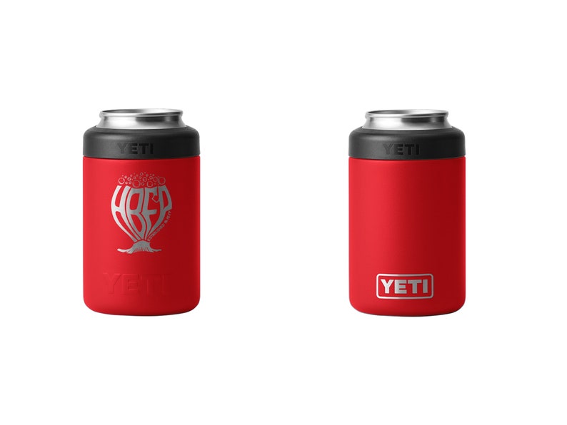 May include: Two red YETI can coolers. One has a silver graphic with the word "HREF" and a tree-like design. The other has a simple red design with the YETI logo in a white rectangle.