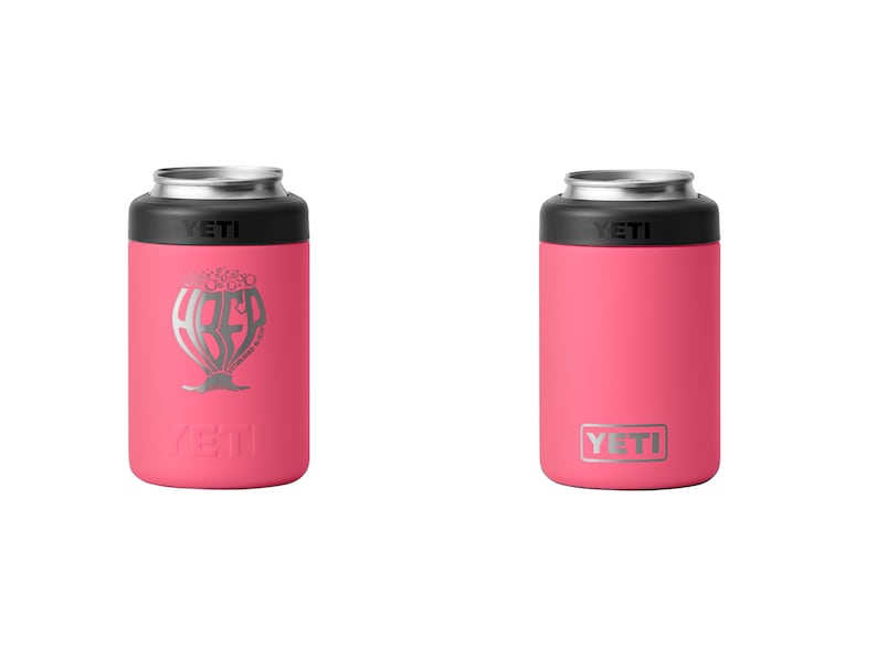 May include: Two pink YETI can insulators. One has a silver graphic of a beer glass with the word "ABED" inside. The other has the YETI logo in silver. Both have a black top and silver rim.