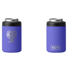 May include: Two purple YETI can coolers. One has a silver graphic of a hot air balloon with the word "YETI" below it. The other has the word "YETI" in a silver rectangle. Both have a black top and silver rim.