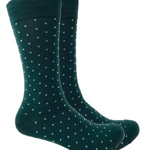 May include: A pair of dark green socks with a white polka dot pattern.