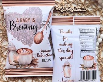 May include: White baby shower favor bags with a coffee theme. The front features a heart made of coffee beans, a spoon, and the text "A Baby Is Brewing." The back says "Thanks for making this day special!" and includes a nutrition facts label.