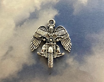 May include: Silver charm of an angel riding a motorcycle with wings spread out.