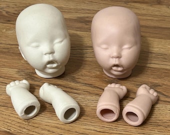 May include: Two doll heads and four doll limbs are displayed. One head is white, the other is pink. The limbs are two pairs of feet. The doll parts are made of a smooth material and are unpainted.