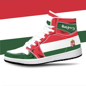 May include: White high-top trainers with a red, white and green striped design. The trainers have the word "Hungary" and the Hungarian coat of arms on the side.