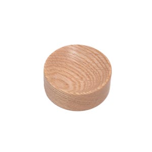 May include: A small, round wooden bowl with a natural wood finish. The bowl is made of oak and has a smooth, polished surface.