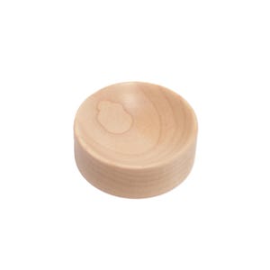 May include: A small, round, wooden bowl with a smooth, light brown finish.