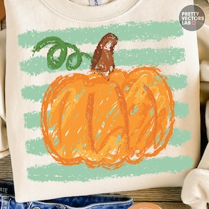 May include: A cream-colored crewneck sweatshirt featuring a graphic of an orange pumpkin with a brown stem and a green vine. The pumpkin is layered over horizontal light green brushstroke stripes. The text Pretty Vectors Lab is visible.