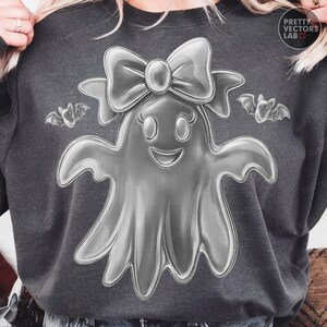 May include: Dark gray sweatshirt featuring a smiling ghost with a bow and two bats. The ghost has a glossy, 3D appearance. The text "Pretty Vectors Lab" is in the upper right corner.