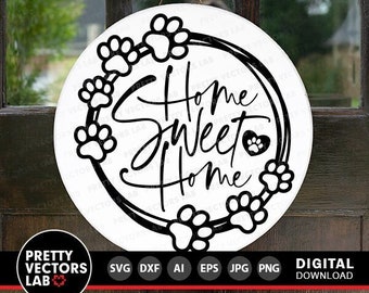 May include: A white round sign with a black paw print wreath and the text "Home Sweet Home" in a decorative font. The wreath has a heart with a paw print inside.