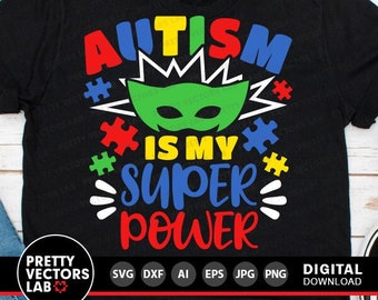 May include: Black t-shirt with the text "Autism is my superpower" in colorful letters. The text is surrounded by puzzle pieces and a green superhero mask.