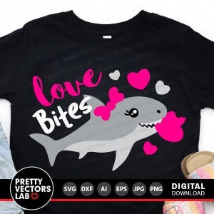 May include: A black t-shirt with a pink and white graphic of a shark with a bow and the text "love bites".