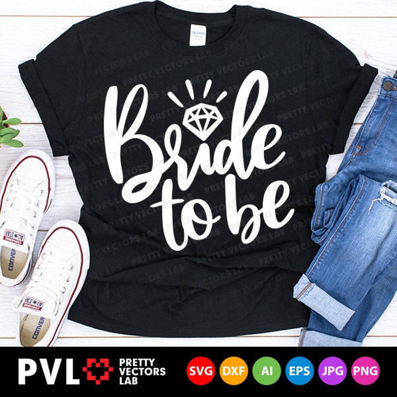 May include: A black t-shirt with the text "Bride to be" in white script with a diamond graphic above the text.