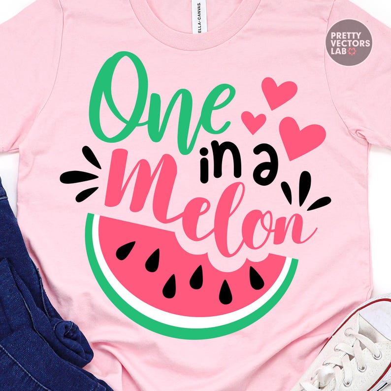 May include: A light pink t-shirt featuring a graphic of a watermelon slice and the text "One in a Melon" in green, black, and pink script and block lettering. The design includes three small pink hearts and black seed shapes on the watermelon.