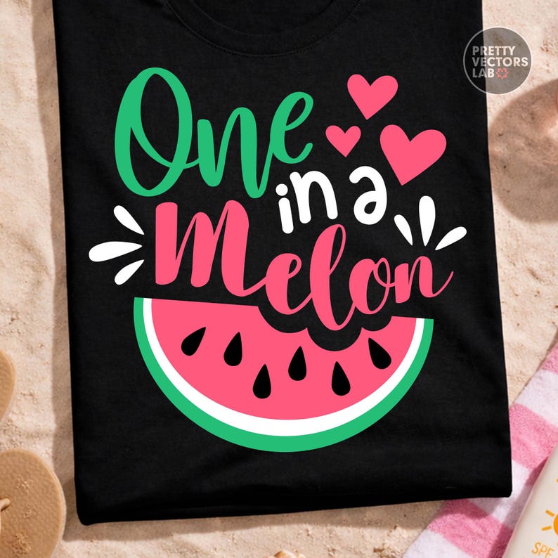 May include: A black t-shirt featuring the text One in a Melon in green and pink script and block lettering. The design includes three pink hearts and a graphic of a watermelon slice with a pink center, white rind, and green outer edge.