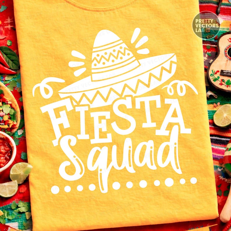 May include: Yellow t-shirt with a white sombrero graphic and the words "FIESTA Squad". The design includes decorative elements and is likely for a festive occasion. The shirt is made of a soft material.