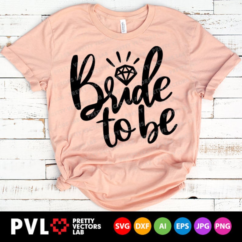 May include: A pink t-shirt with the text "Bride to be" in black script with a diamond graphic above the text.